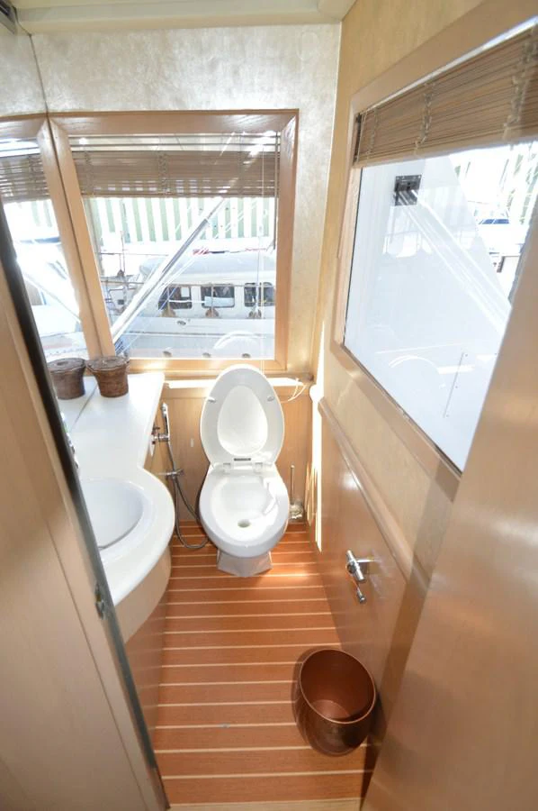 a bathroom with a toilet and a sink aboard SEAQUEST Yacht for Sale