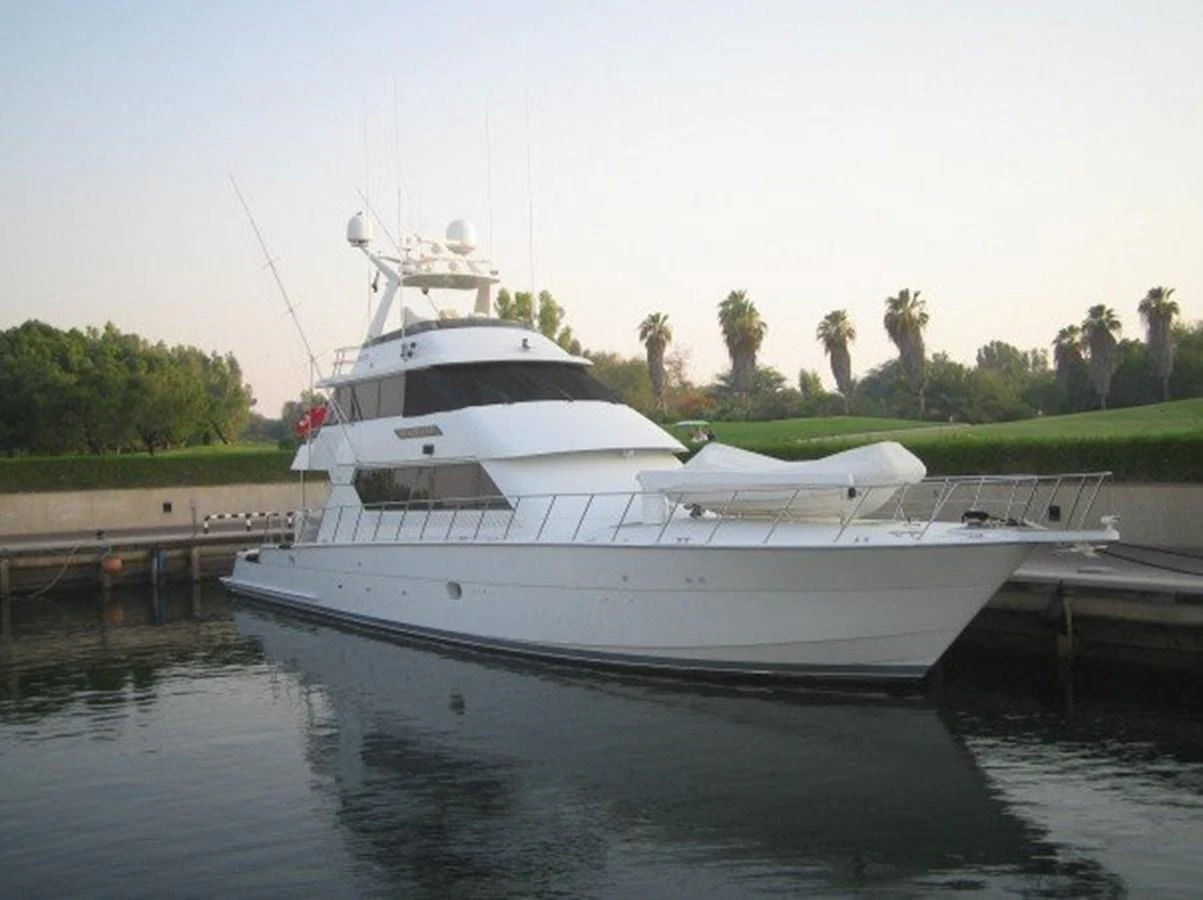 a white boat on a body of water aboard SEAQUEST Yacht for Sale
