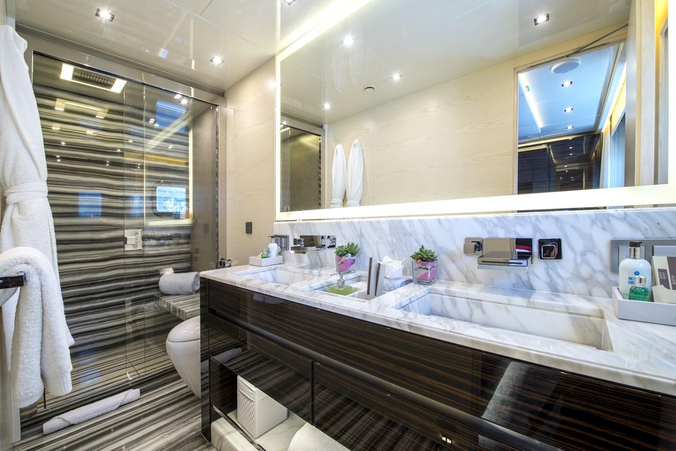 a bathroom with a glass shower aboard AXIOS Yacht for Sale