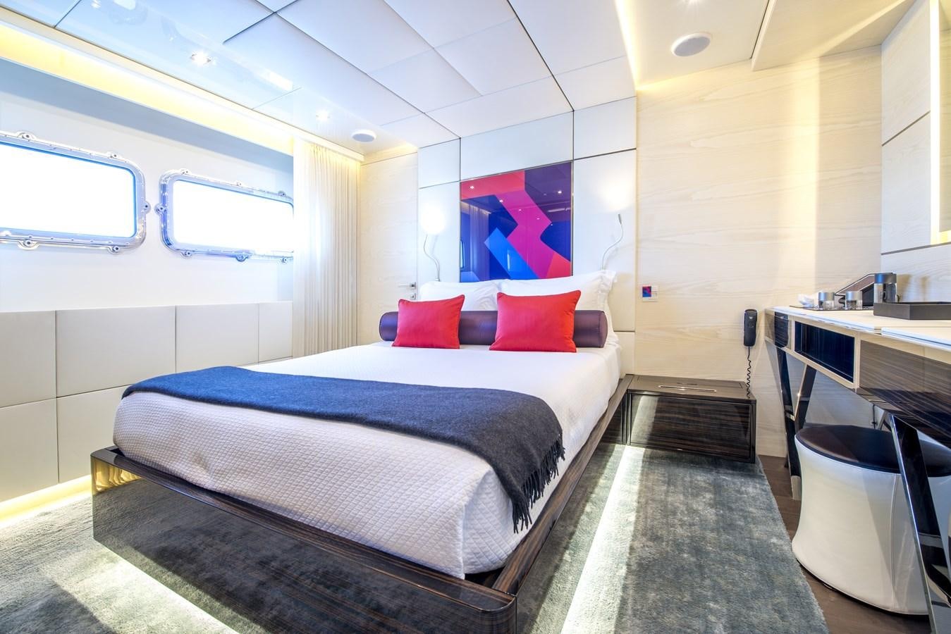 a room with a bed and desk aboard AXIOS Yacht for Sale