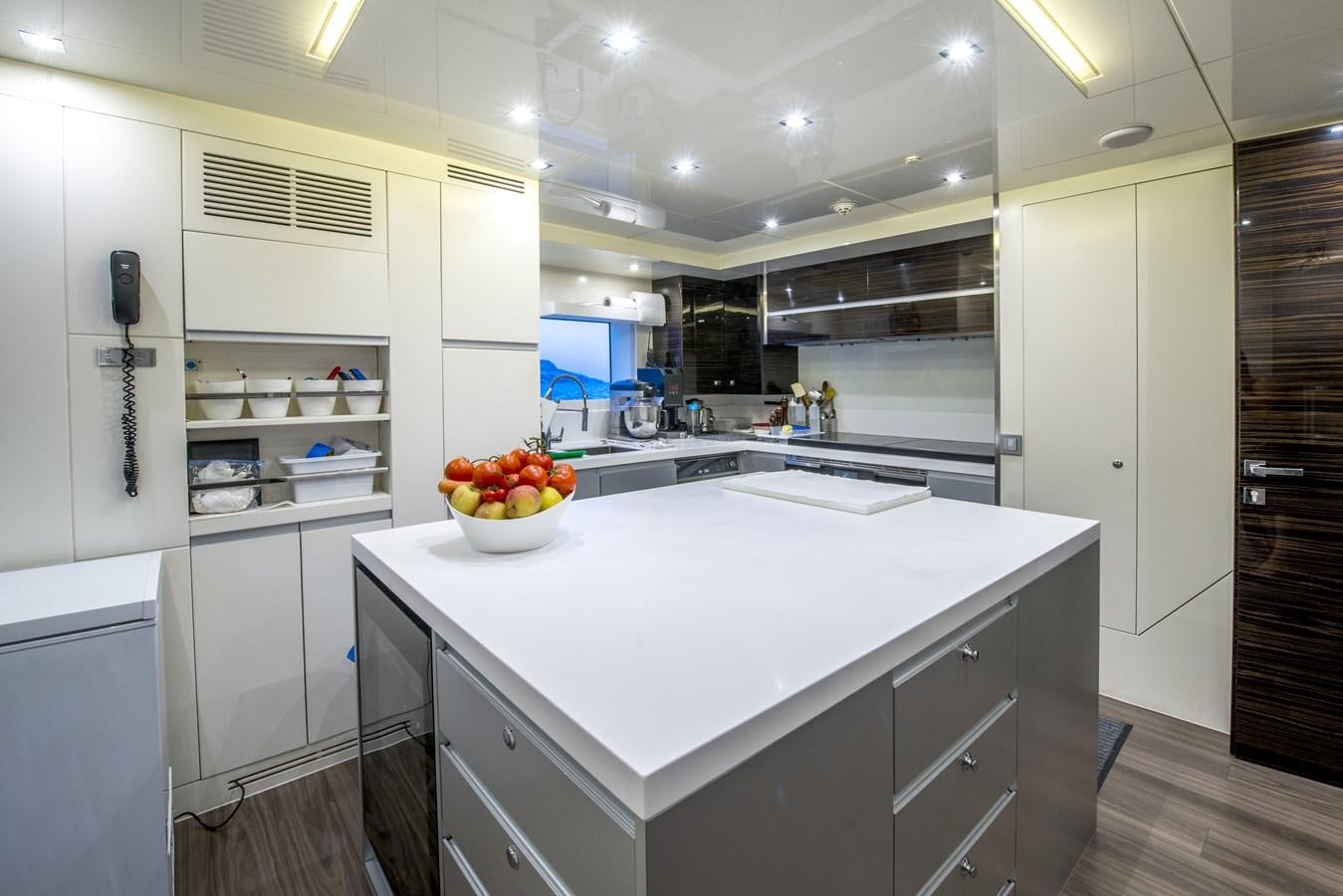 a kitchen with white cabinets aboard AXIOS Yacht for Sale