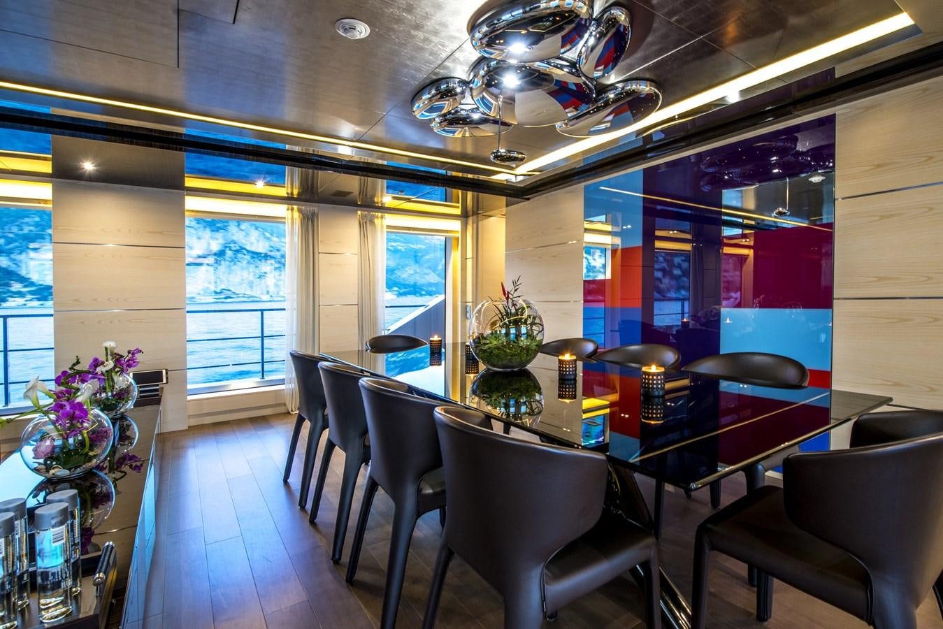 a large room with a table and chairs aboard AXIOS Yacht for Sale
