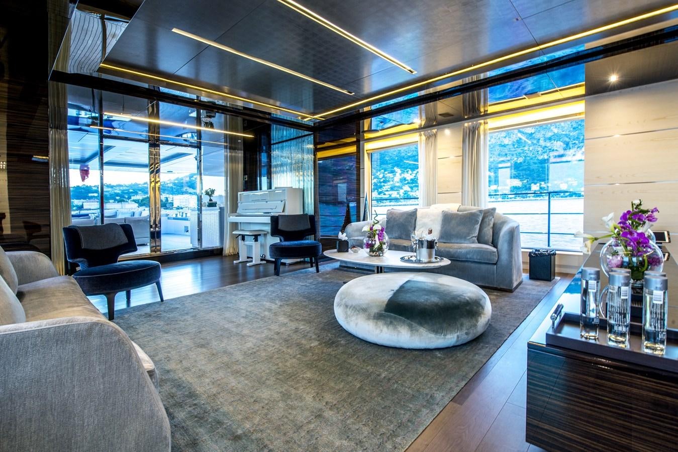 a living room with a large glass wall aboard AXIOS Yacht for Sale