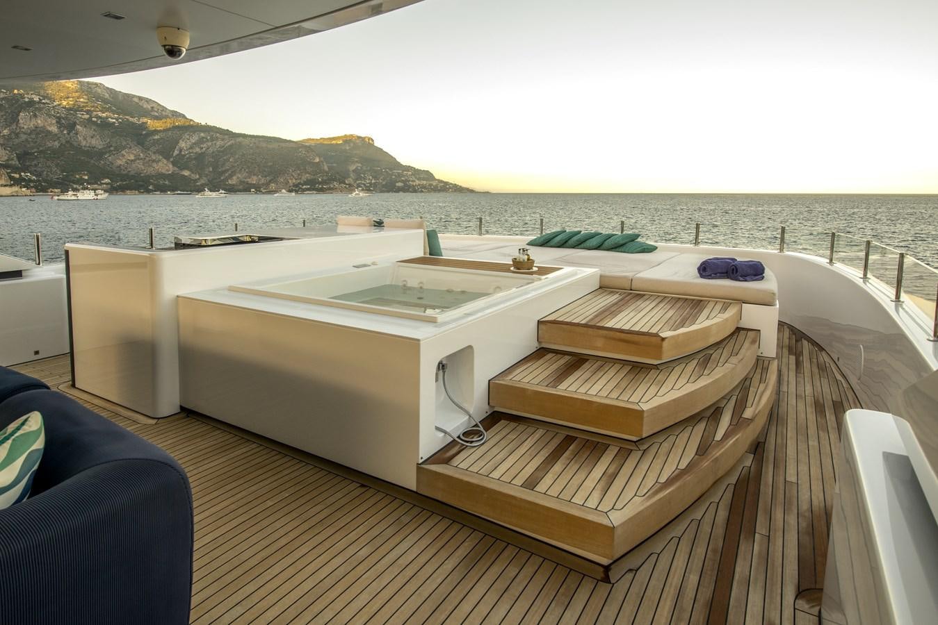 a deck with a large pool aboard AXIOS Yacht for Sale