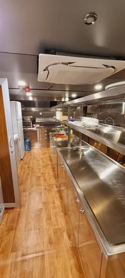 a kitchen with a large island aboard SINAN BEY Yacht for Sale