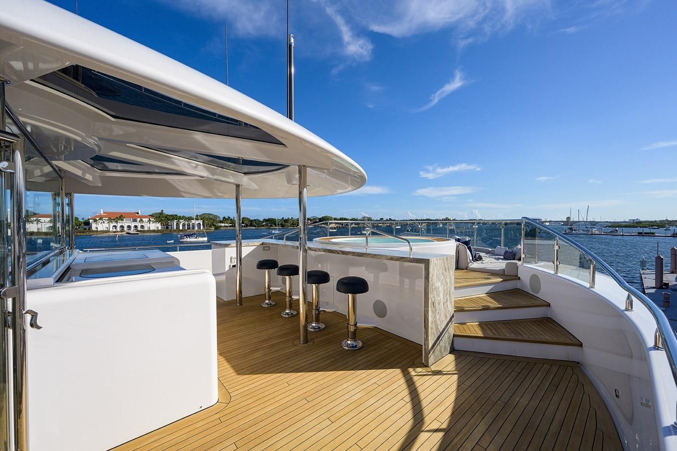 a deck with a table and chairs on it aboard SEANASH Yacht for Charter