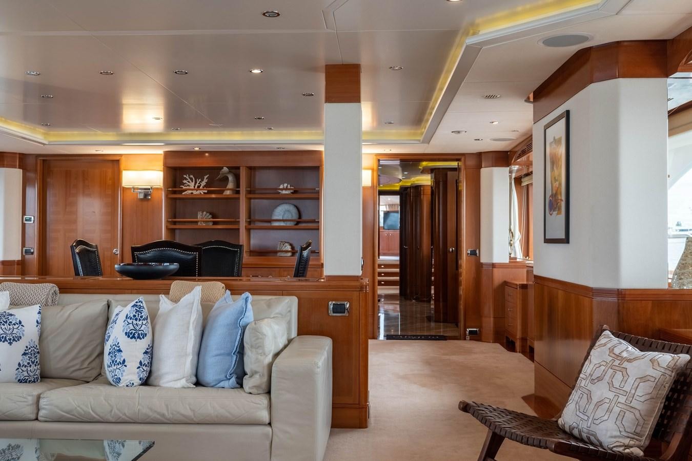 a living room with a couch and a wood cabinet aboard ALEGRIA Yacht for Sale