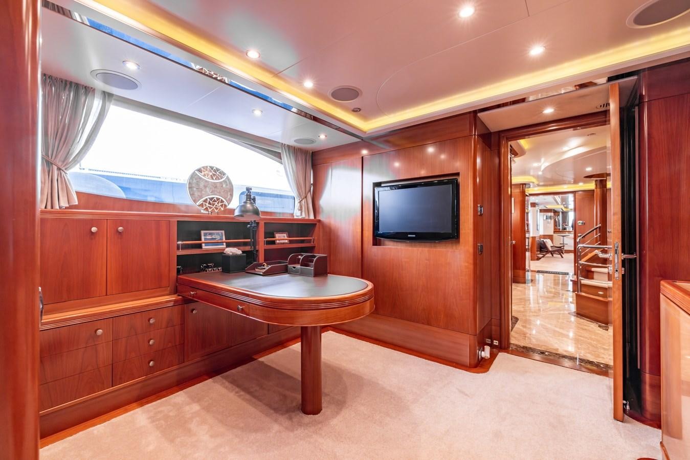 a room with a table and a tv aboard ALEGRIA Yacht for Sale