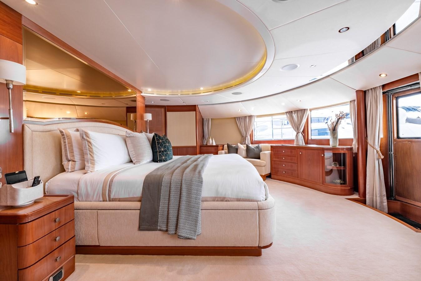 a bedroom with a bed and a desk aboard ALEGRIA Yacht for Sale
