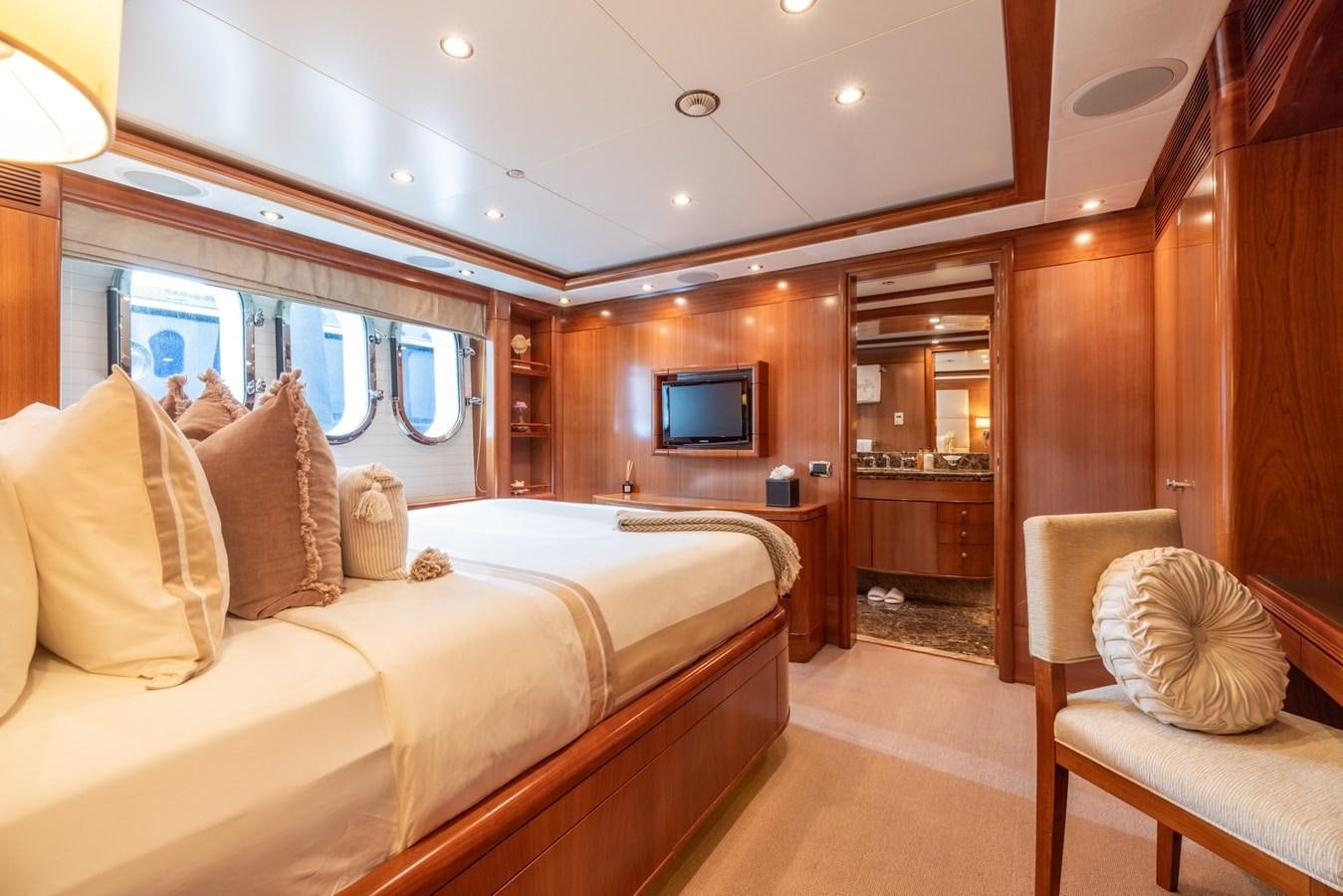 a room with a bed and a television aboard ALEGRIA Yacht for Sale