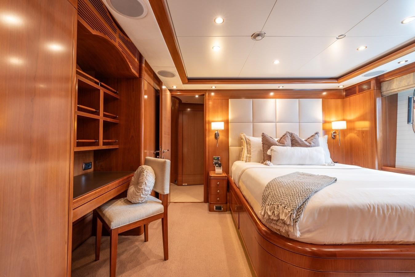 a room with a bed and a chair aboard ALEGRIA Yacht for Sale