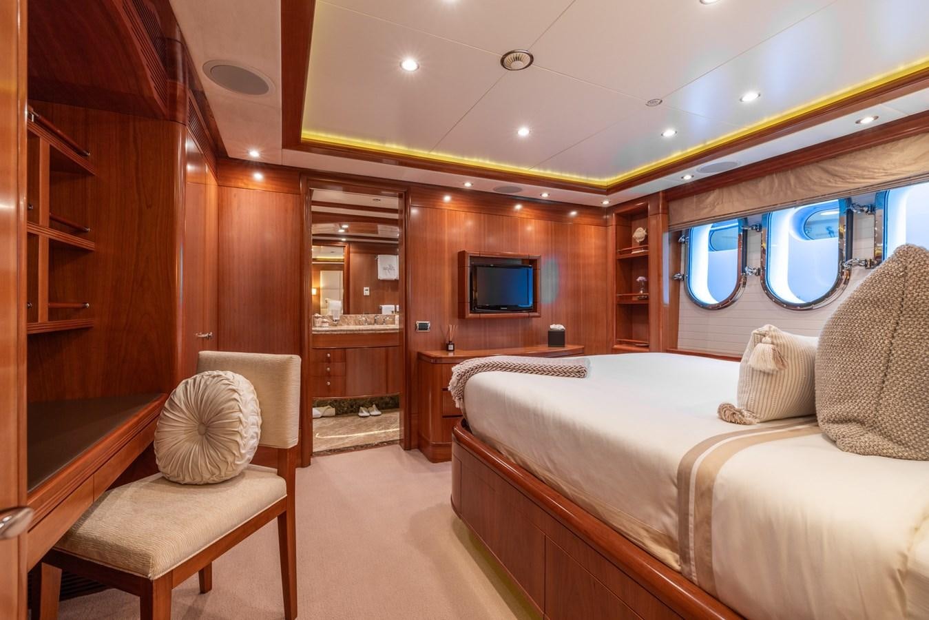 a room with a bed and a television aboard ALEGRIA Yacht for Sale
