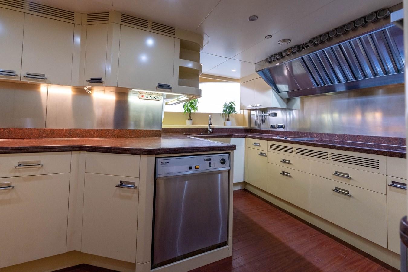 a kitchen with white cabinets aboard ALEGRIA Yacht for Sale