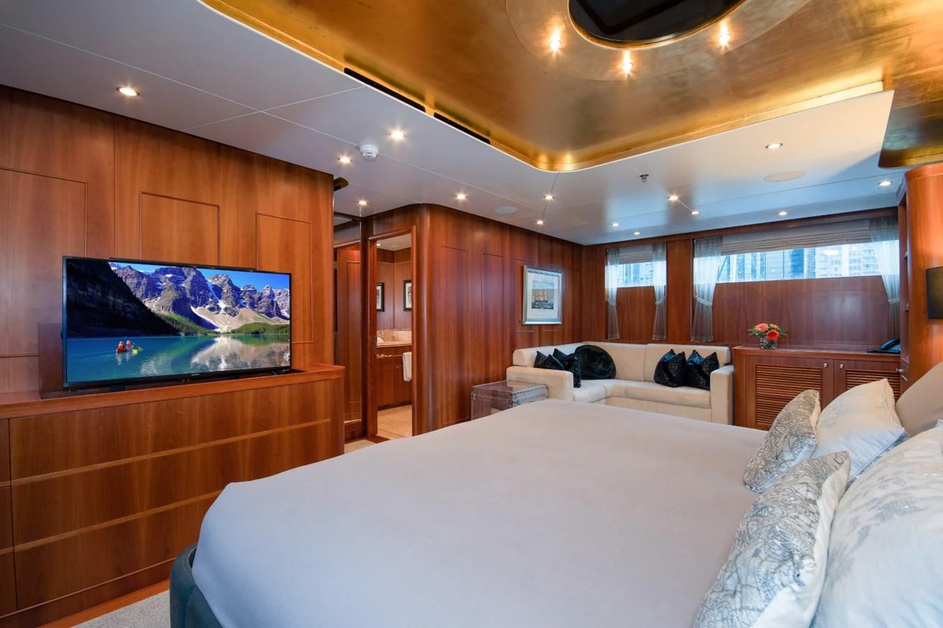 a room with a bed and a tv on the wall aboard KOMOKWA Yacht for Charter