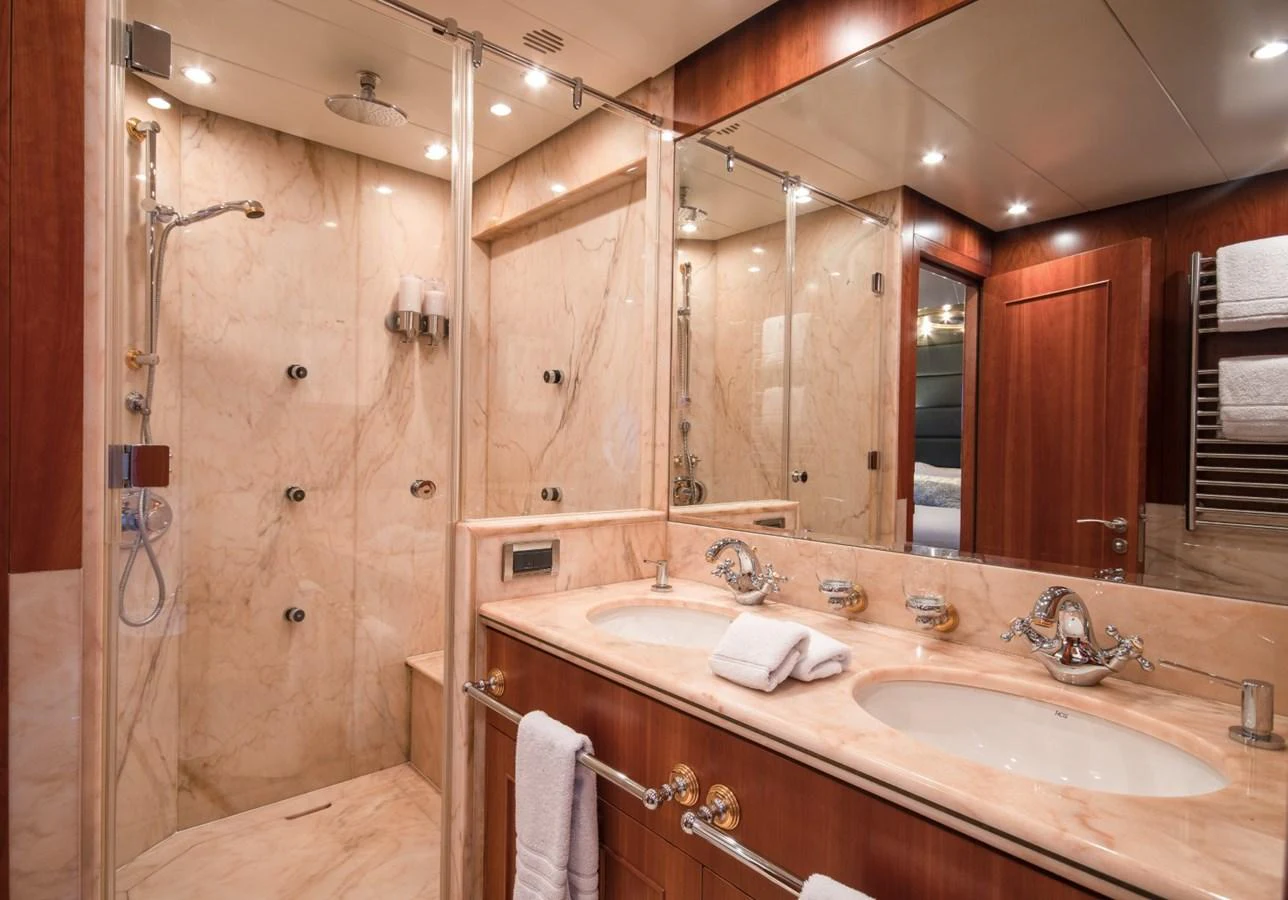 a bathroom with a shower and sink aboard KOMOKWA Yacht for Charter