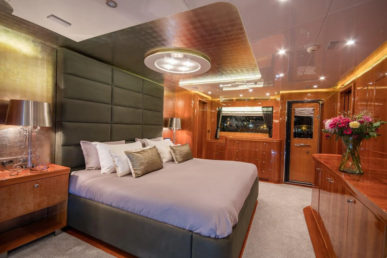 a bedroom with a bed and a fireplace aboard KOMOKWA Yacht for Charter