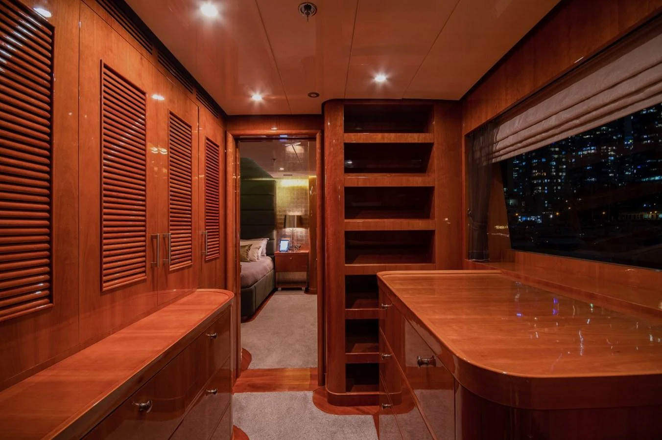 a room with wooden cabinets and a table with a bench aboard KOMOKWA Yacht for Charter
