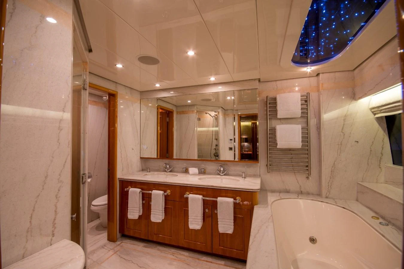 a bathroom with a large mirror aboard KOMOKWA Yacht for Charter