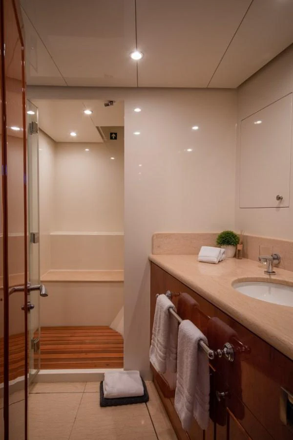 a bathroom with a sink and a shower aboard KOMOKWA Yacht for Charter