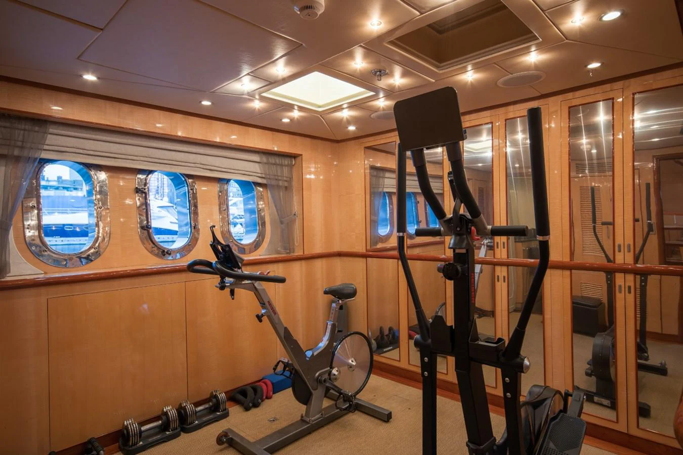 a room with a bicycle and a mirror aboard KOMOKWA Yacht for Charter