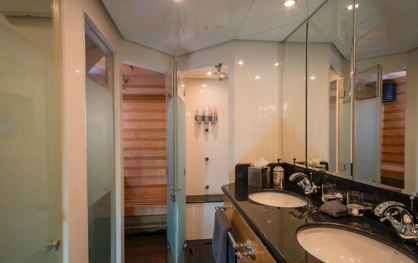 a bathroom with a sink and a mirror aboard KOMOKWA Yacht for Charter