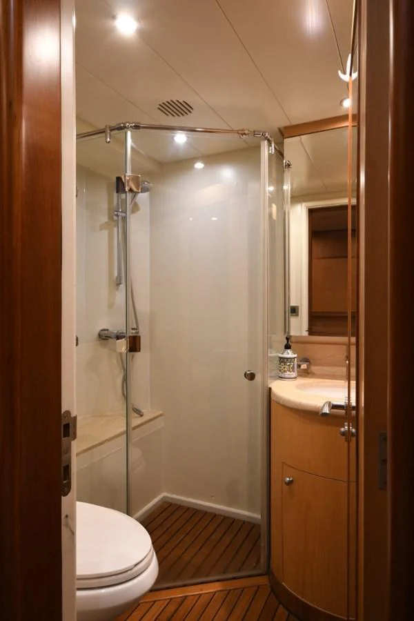 a bathroom with a shower unit and toilet aboard KOMOKWA Yacht for Charter
