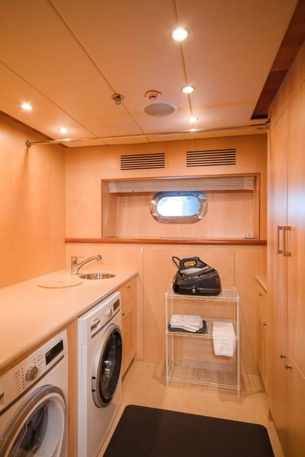 a small kitchen with a washer and dryer aboard KOMOKWA Yacht for Charter