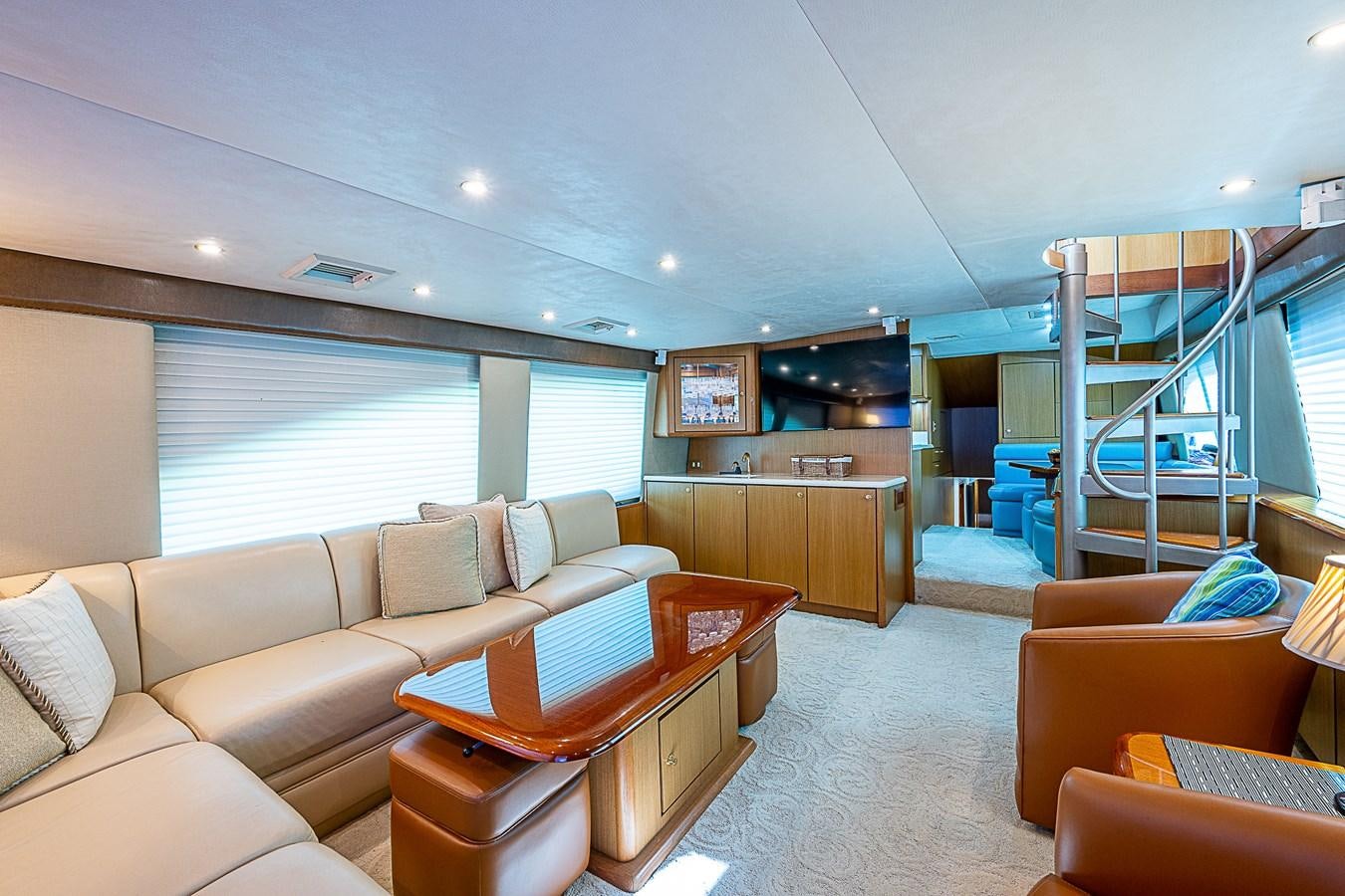 a living room with a large blue staircase aboard THIS LITTLE PIGGY Yacht for Sale