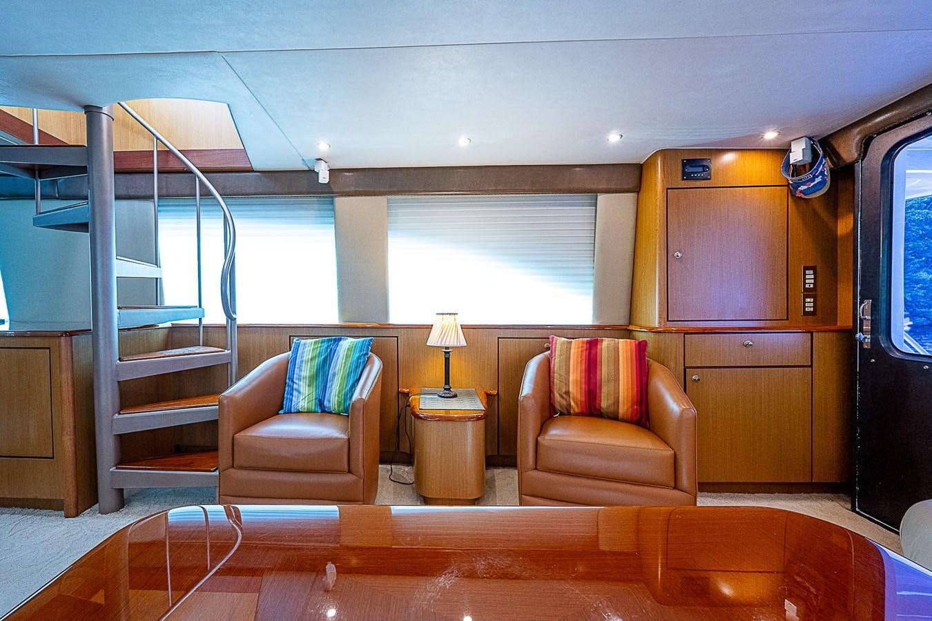 a living room with a staircase and a staircase aboard THIS LITTLE PIGGY Yacht for Sale