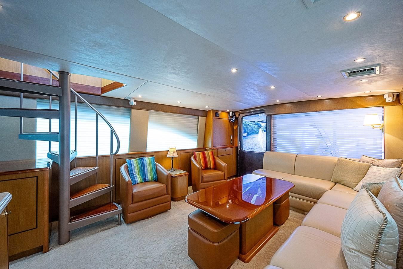 a living room with a staircase and a glass door aboard THIS LITTLE PIGGY Yacht for Sale