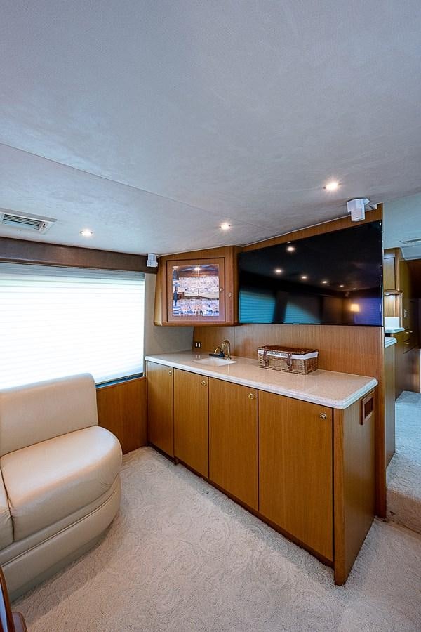 a room with a couch and a sink aboard THIS LITTLE PIGGY Yacht for Sale