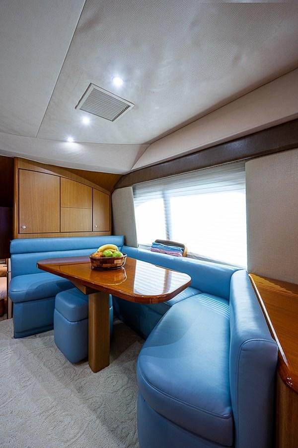 a room with a table and chairs aboard THIS LITTLE PIGGY Yacht for Sale