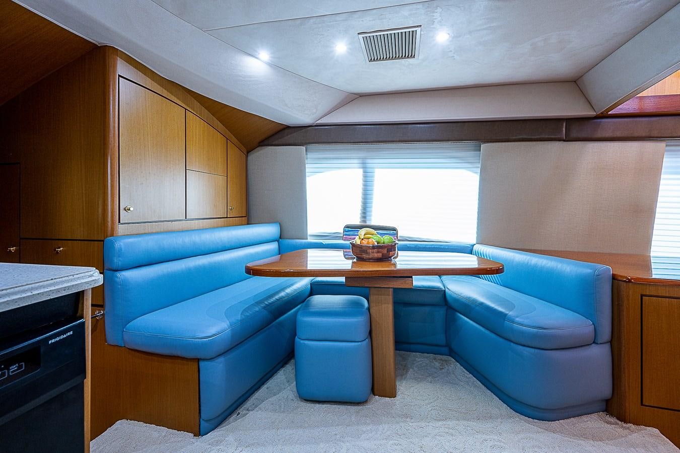 a room with a table and chairs aboard THIS LITTLE PIGGY Yacht for Sale