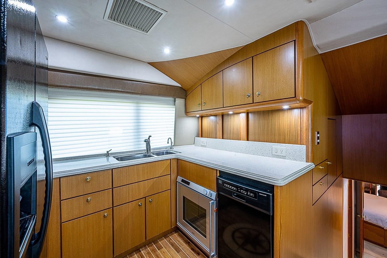 a kitchen with wooden cabinets aboard THIS LITTLE PIGGY Yacht for Sale