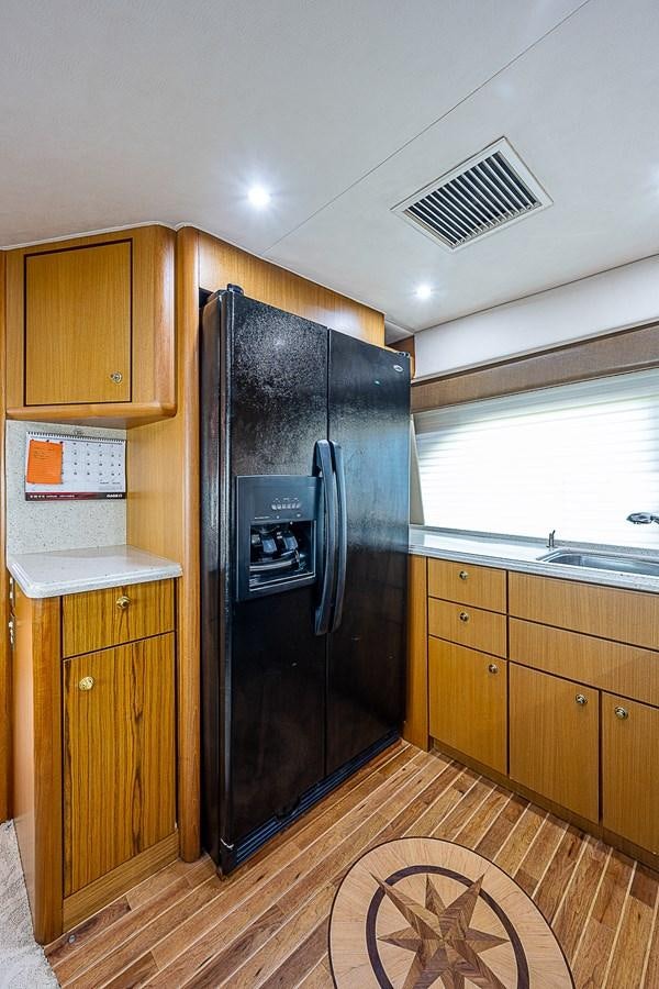 a kitchen with a refrigerator aboard THIS LITTLE PIGGY Yacht for Sale