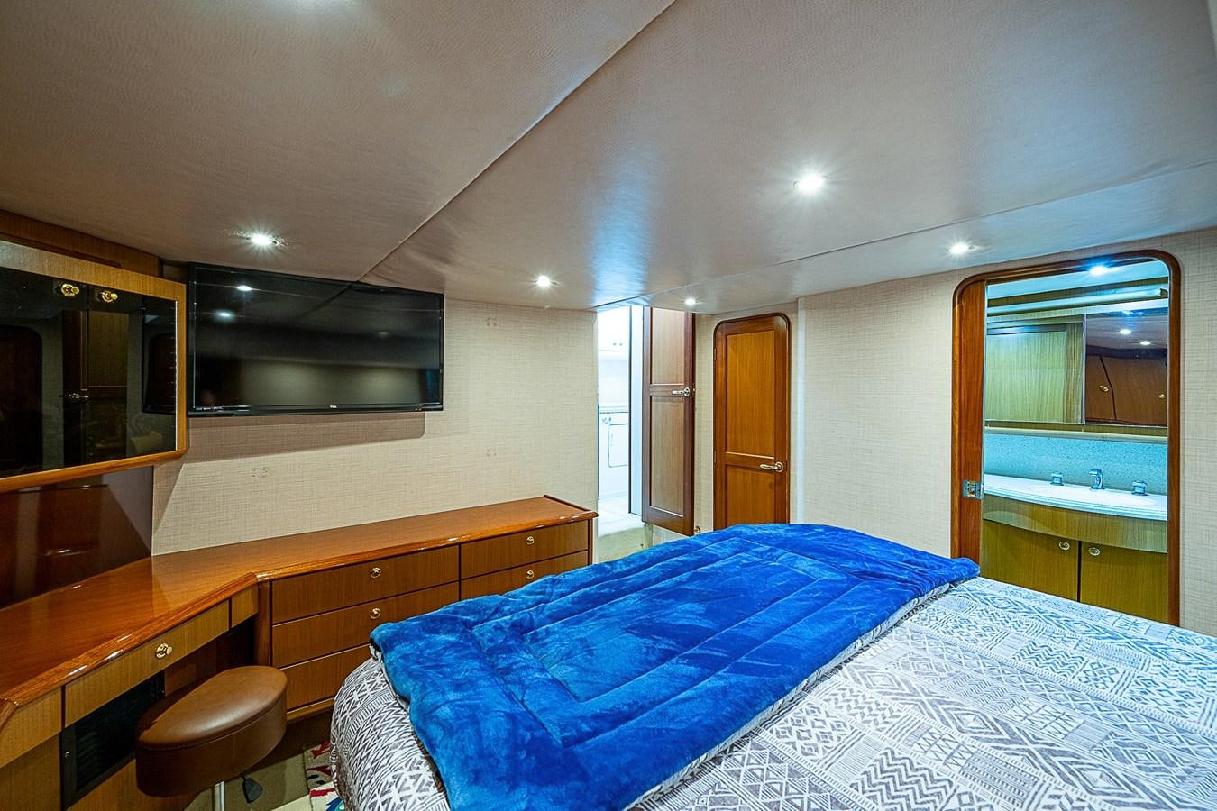 a bedroom with a bed and a desk aboard THIS LITTLE PIGGY Yacht for Sale