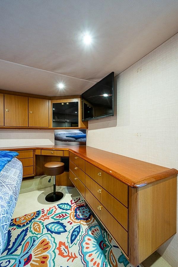 a kitchen with a wood counter and stools aboard THIS LITTLE PIGGY Yacht for Sale