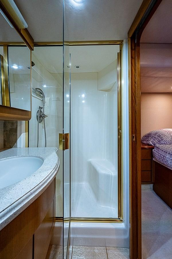 a bathroom with a glass shower aboard THIS LITTLE PIGGY Yacht for Sale