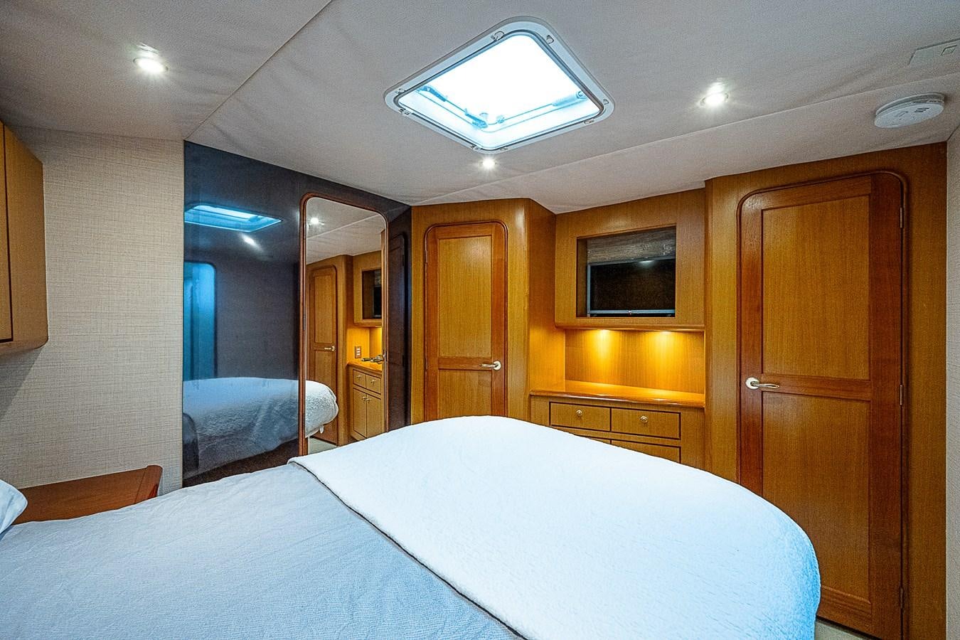 a hotel room with a bed and a closet aboard THIS LITTLE PIGGY Yacht for Sale