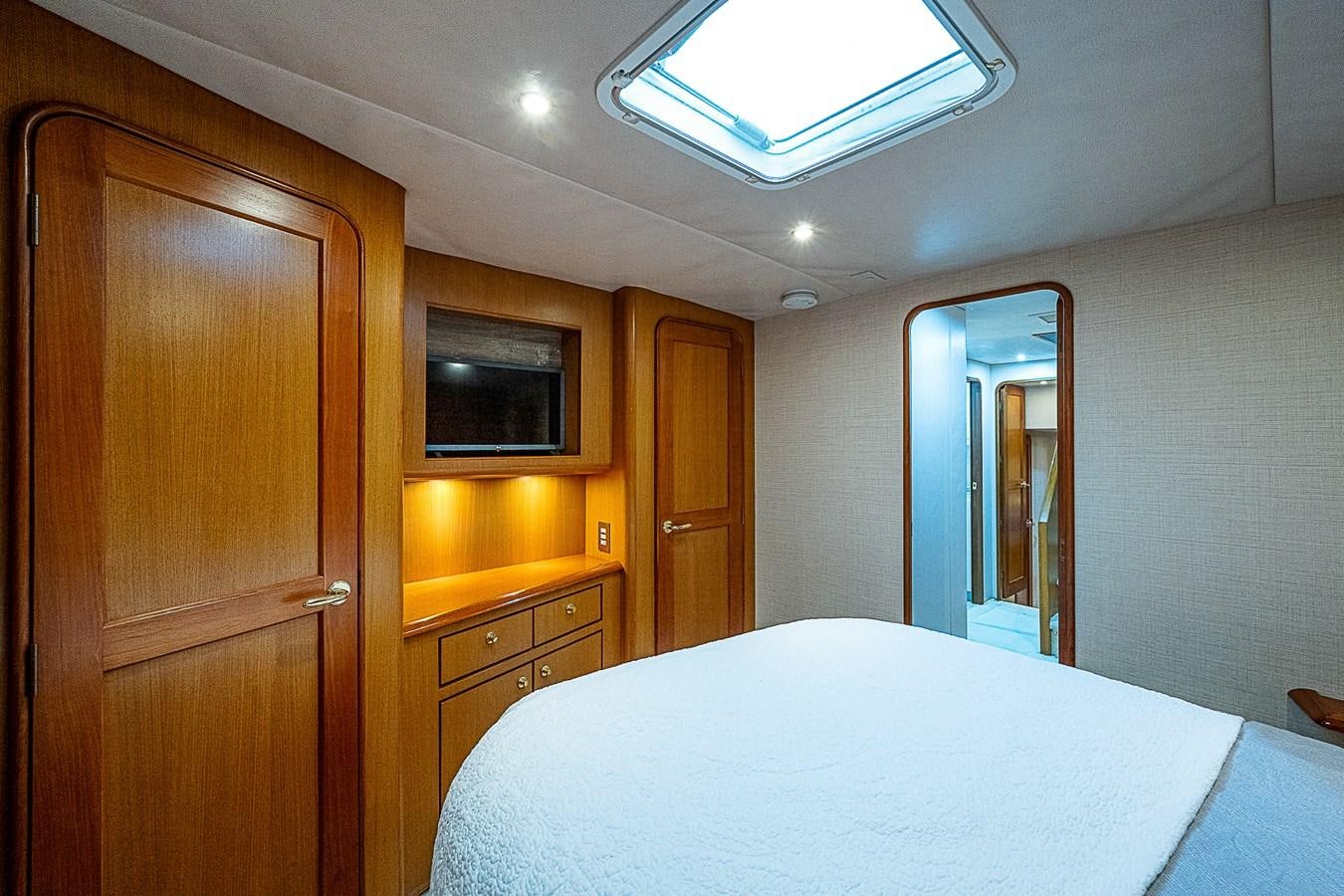 a room with a bed and a television aboard THIS LITTLE PIGGY Yacht for Sale