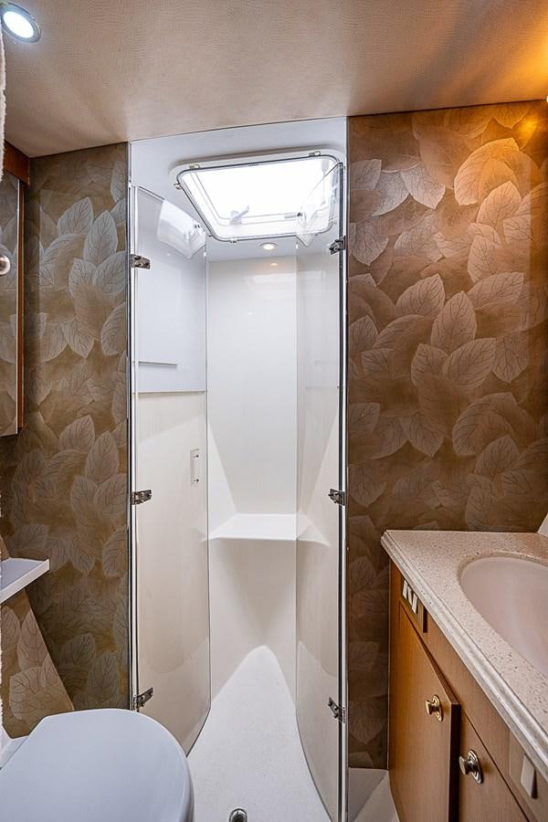 a bathroom with a glass shower aboard THIS LITTLE PIGGY Yacht for Sale