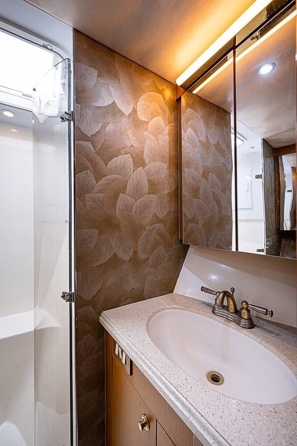 a bathroom with a sink and a shower aboard THIS LITTLE PIGGY Yacht for Sale