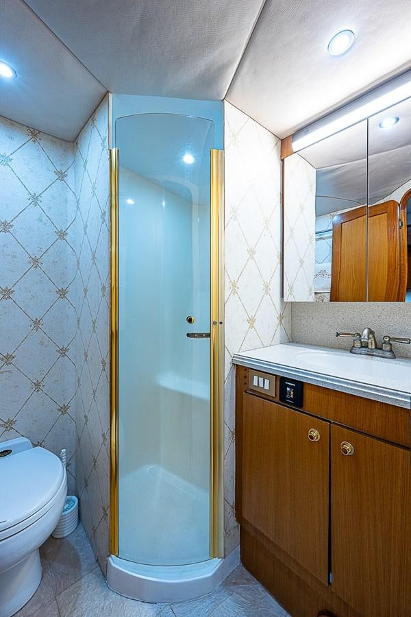 a bathroom with a shower and sink aboard THIS LITTLE PIGGY Yacht for Sale