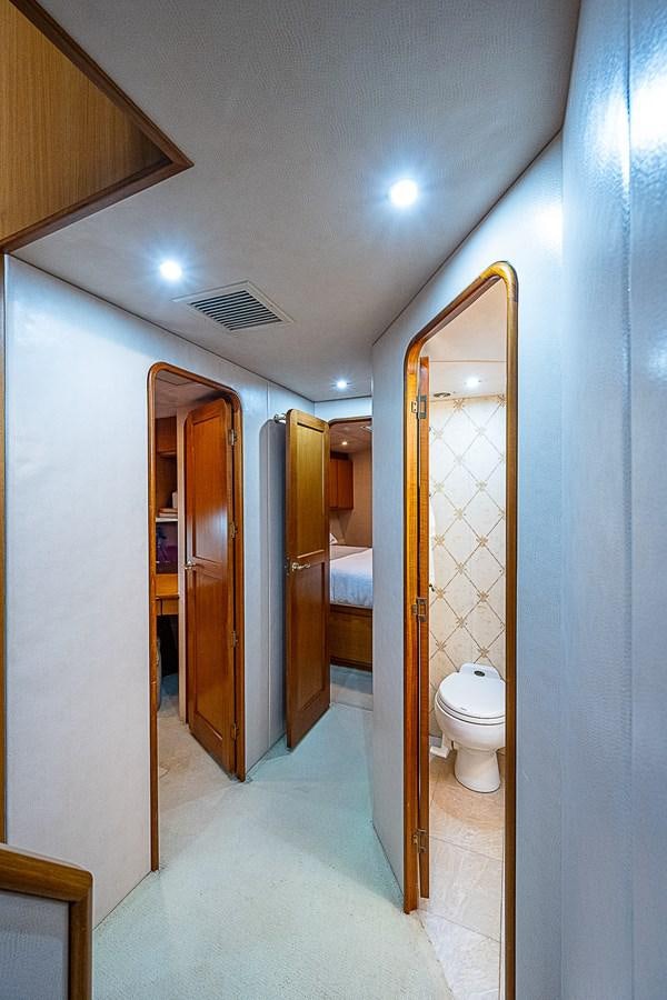 a bathroom with a toilet and a mirror aboard THIS LITTLE PIGGY Yacht for Sale