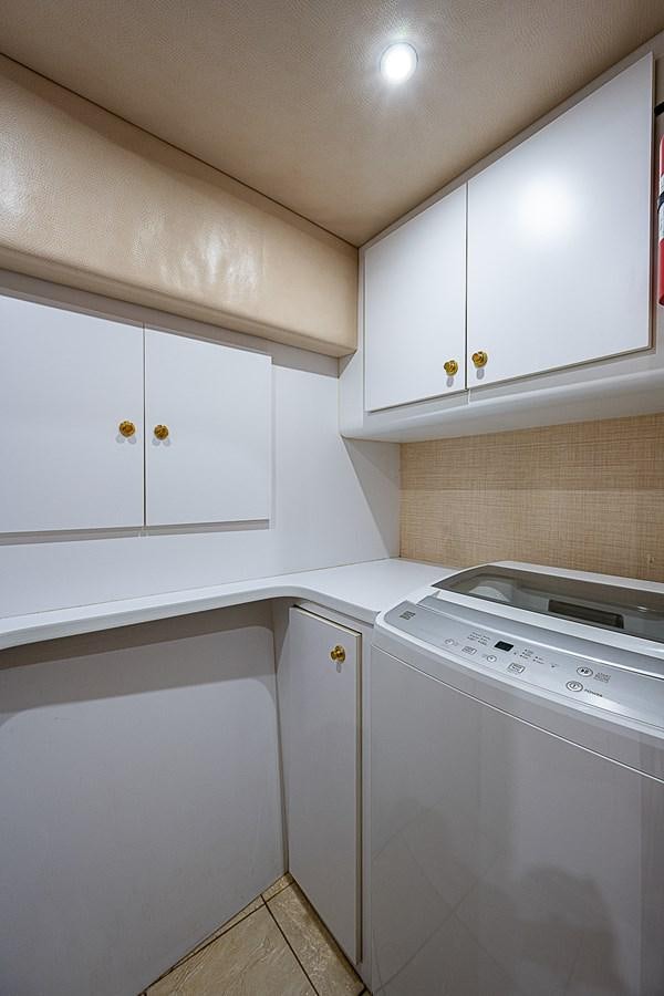 a white kitchen with white cabinets aboard THIS LITTLE PIGGY Yacht for Sale