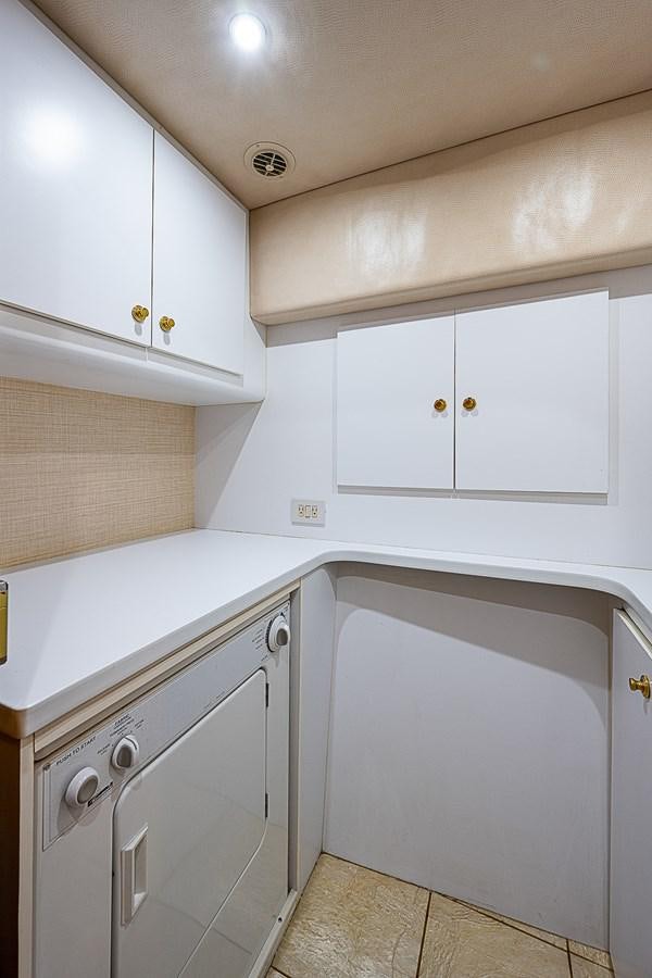 a kitchen with white cabinets aboard THIS LITTLE PIGGY Yacht for Sale