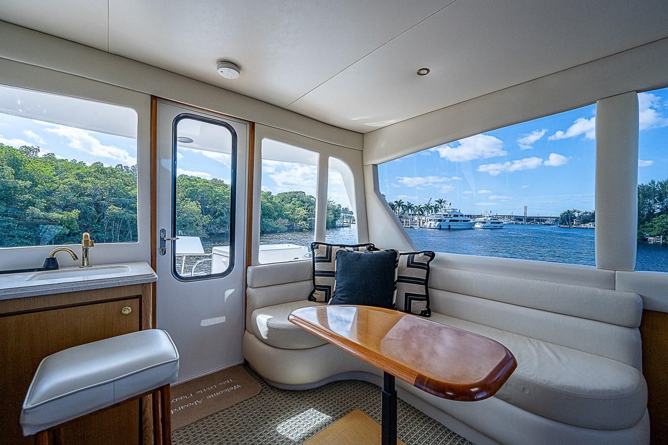 a room with a table and chairs aboard THIS LITTLE PIGGY Yacht for Sale