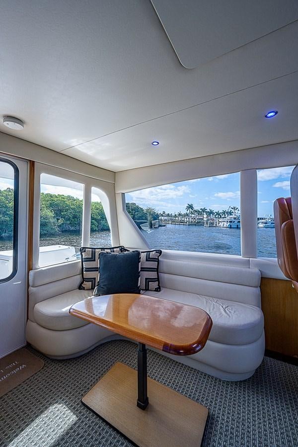 a living room with a large window aboard THIS LITTLE PIGGY Yacht for Sale