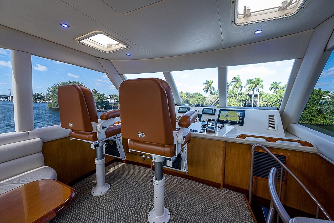 inside of a vehicle with a desk and chairs and a window aboard THIS LITTLE PIGGY Yacht for Sale