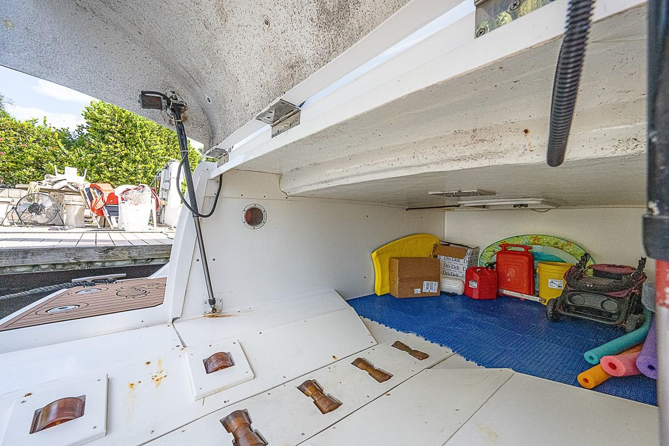 a white car with a blue tarp on the hood aboard THIS LITTLE PIGGY Yacht for Sale